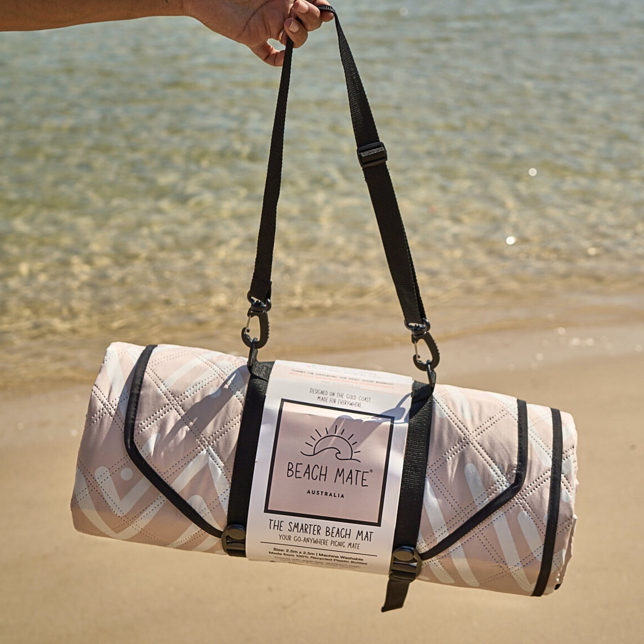 Beach Mate Palm Beach sand-free recycled beach mat with carry strap by the water