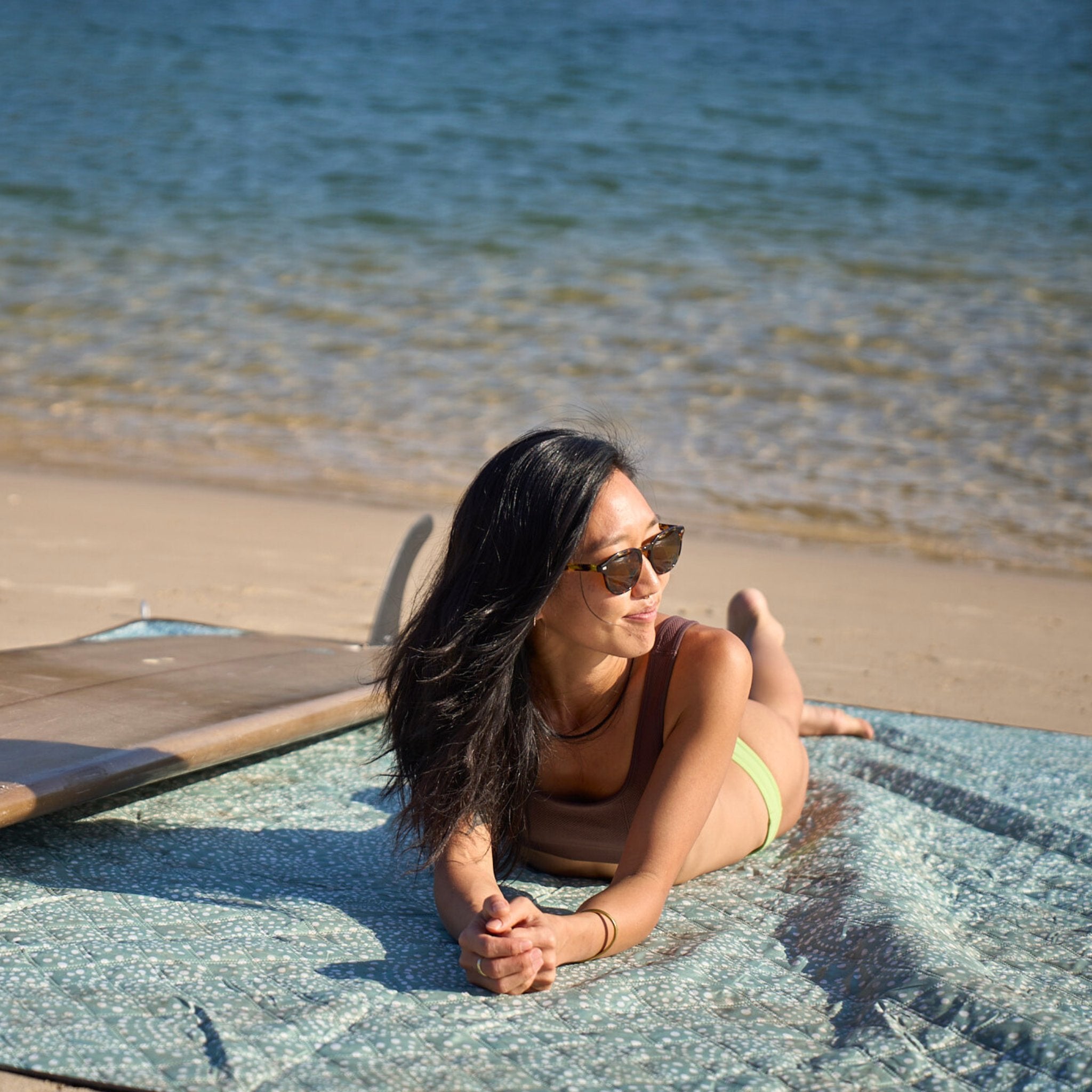Relaxing on the Snapper Rocks Beach Mate sand-free recycled mat after a surf.