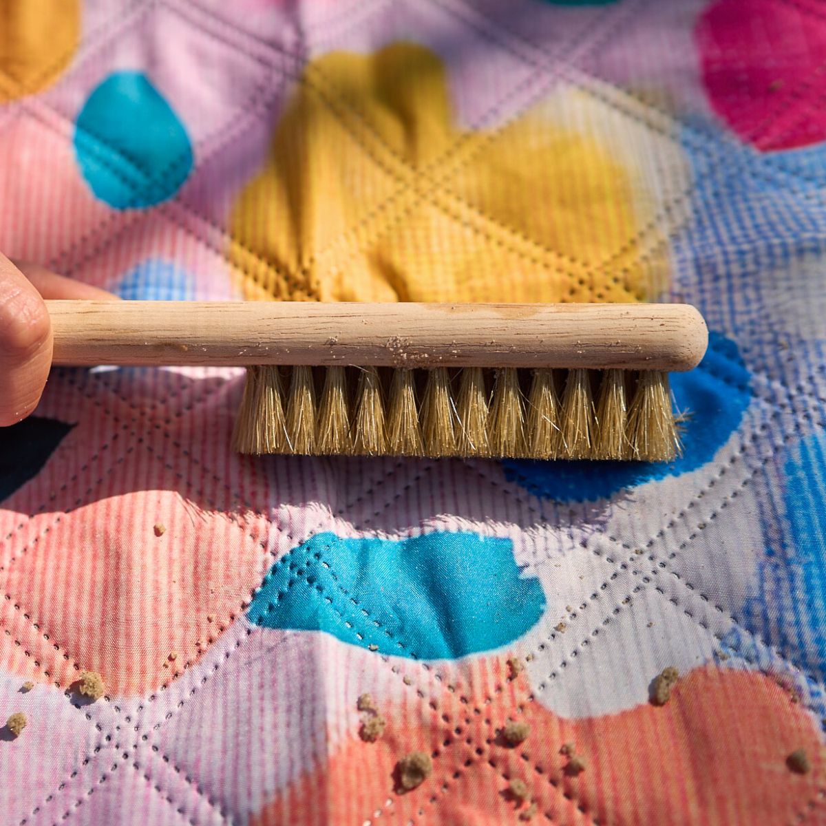Brushing sand off a Beach Mate with included sand brush.