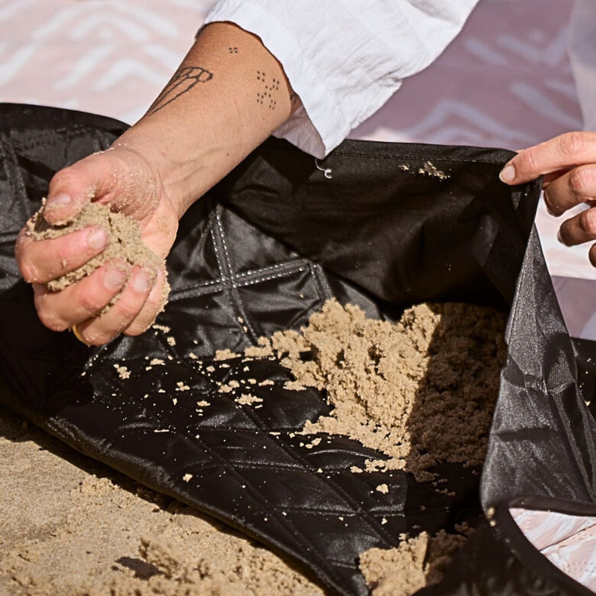 Filling up corner sand pockets down on a windy day to weigh down the Beach Mate