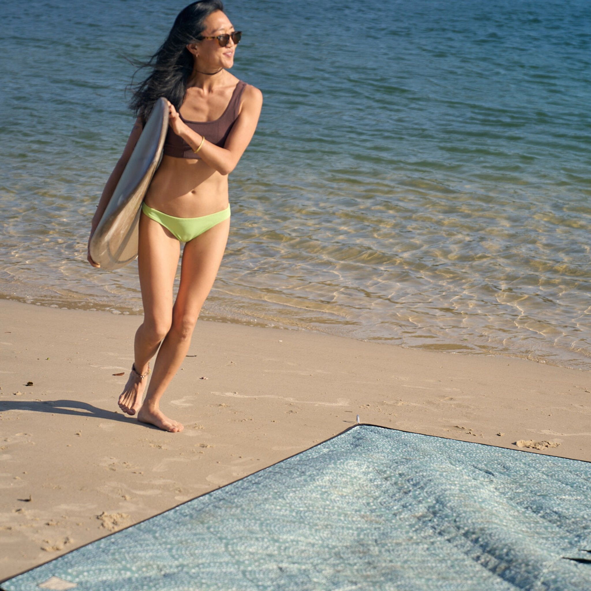 Walking from the ocean to unwind on the Snapper Rocks sand-free beach mat.